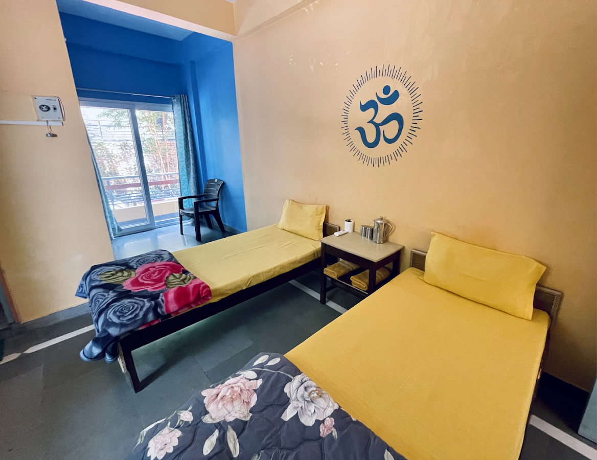 Shared room with twin beds and Om symbol